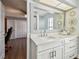 Well-lit bathroom featuring a large mirror, vanity with drawers, and decorative wall art at 14078 Leeward Dr, Seminole, FL 33776