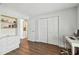 Cozy bedroom with laminate floors, white built-in shelving, and closet at 14078 Leeward Dr, Seminole, FL 33776