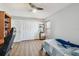 Well-lit bedroom with gray walls, bunk bed, and closet with laminate floors at 14078 Leeward Dr, Seminole, FL 33776