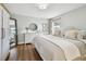 Comfortable bedroom with neutral walls, hardwood floors and ample natural light at 14078 Leeward Dr, Seminole, FL 33776