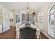 Elegant dining room featuring wood floors, stylish chandelier, and a china cabinet at 14078 Leeward Dr, Seminole, FL 33776