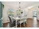 Bright dining room with wood floors, large windows, and a chandelier at 14078 Leeward Dr, Seminole, FL 33776
