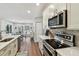 Modern kitchen with stainless steel appliances and a view to the dining area at 14078 Leeward Dr, Seminole, FL 33776