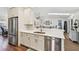 Modern kitchen featuring stainless steel appliances, white cabinetry, and open layout to the living area at 14078 Leeward Dr, Seminole, FL 33776
