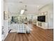 Open-concept living space features hardwood floors, lots of sunlight, modern ceiling fan, and stylish decor at 14078 Leeward Dr, Seminole, FL 33776