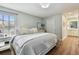 Bright main bedroom with a large bed, wood floors, and an ensuite bathroom at 14078 Leeward Dr, Seminole, FL 33776