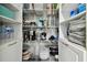 Organized pantry with multiple shelves containing food items and kitchen appliances at 14078 Leeward Dr, Seminole, FL 33776