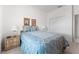 Bright bedroom showcasing a bed with decorative bedding, twin lamps, and a double door closet at 15703 Walden Ave, Tampa, FL 33618
