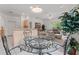 Open concept breakfast nook with a glass table leading to the living room and kitchen at 15703 Walden Ave, Tampa, FL 33618