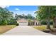 Charming single-story home with a well-manicured lawn, mature trees and long driveway at 15703 Walden Ave, Tampa, FL 33618