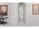 Hallway featuring tile flooring, arched doorways, and decorative accents at 15703 Walden Ave, Tampa, FL 33618