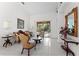 Comfortable living room featuring tile floors, large mirror and sliding glass door access to backyard at 15703 Walden Ave, Tampa, FL 33618