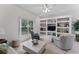 Comfortable living room with built-in shelving, neutral tones, and a large window at 15703 Walden Ave, Tampa, FL 33618