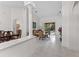 Bright living room with tile flooring, decorative column, and sliding glass doors leading to outdoor space at 15703 Walden Ave, Tampa, FL 33618