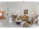 Open concept living and dining area with tile flooring, and decorative columns at 15703 Walden Ave, Tampa, FL 33618