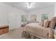Comfortable main bedroom with a dresser, seating, and natural light from the window at 15703 Walden Ave, Tampa, FL 33618