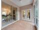 Enclosed patio with brick flooring featuring sliding doors and views of the interior dining and living areas at 15703 Walden Ave, Tampa, FL 33618