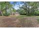 Sprawling yard with mature trees surrounds a beautiful home, offering serene outdoor living at 15703 Walden Ave, Tampa, FL 33618