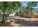 Backyard featuring a patio, exterior building and mature trees at 1610 15Th N St, St Petersburg, FL 33704