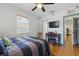 Bedroom with hardwood floors, ceiling fan, tv and blue trim at 1610 15Th N St, St Petersburg, FL 33704