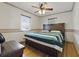 Comfortable bedroom with a ceiling fan, hardwood floors and natural light from the windows at 1610 15Th N St, St Petersburg, FL 33704