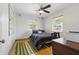 Bright bedroom with hardwood floors, ceiling fan, natural light and simple furnishings at 1610 15Th N St, St Petersburg, FL 33704