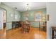 Traditional dining room features hardwood floors, wood table and chairs, and multiple windows at 1610 15Th N St, St Petersburg, FL 33704
