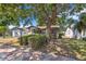 Charming single-story home featuring a well-maintained lawn and mature shade trees at 1610 15Th N St, St Petersburg, FL 33704