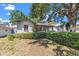 Single-story home showing the mature bushes in the front yard at 1610 15Th N St, St Petersburg, FL 33704
