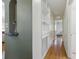 Hallway with hardwood floors, built-in shelving with glass shelving and unique archway at 1610 15Th N St, St Petersburg, FL 33704