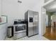 Clean kitchen features stainless steel appliances and white cabinets, with access to dining room at 1610 15Th N St, St Petersburg, FL 33704