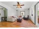 Cozy living room featuring hardwood floors, a ceiling fan, and ample natural light at 1610 15Th N St, St Petersburg, FL 33704