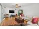 Spacious living room with hardwood floors, a ceiling fan, a TV, and arched entryway at 1610 15Th N St, St Petersburg, FL 33704