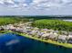 Aerial view shows homes nestled alongside a lake, showcasing the community's waterfront charm and natural surroundings at 16113 Rambling Rd, Odessa, FL 33556