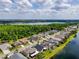 Aerial view highlighting the neighborhood near lake with trees, showcasing waterfront living and lush landscaping at 16113 Rambling Rd, Odessa, FL 33556