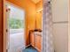 Bathroom featuring a vanity with patterned shower curtain, tile shower, and a door to screened-in patio at 16113 Rambling Rd, Odessa, FL 33556