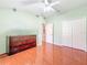 Bedroom features a double closet, wood floors, and green walls at 16113 Rambling Rd, Odessa, FL 33556