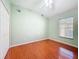 The bedroom has hardwood floors, neutral walls, and a ceiling fan at 16113 Rambling Rd, Odessa, FL 33556
