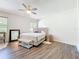 This bedroom features an upholstered bed, wood floors, and a neutral color palette at 16113 Rambling Rd, Odessa, FL 33556