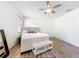 Comfortable bedroom featuring a ceiling fan and a large window at 16113 Rambling Rd, Odessa, FL 33556