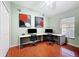 Bedroom featuring wood floors and two desks at 16113 Rambling Rd, Odessa, FL 33556