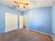 This bedroom has a neutral carpet, blue walls, and a large closet at 16113 Rambling Rd, Odessa, FL 33556