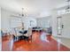 Bright dining room boasts wood floors, stylish chairs, and a modern light fixture for inviting meals and gatherings at 16113 Rambling Rd, Odessa, FL 33556