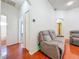 This hallway features a comfortable sofa and cherry wood floors at 16113 Rambling Rd, Odessa, FL 33556