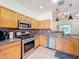 Charming kitchen includes stainless appliances, stone countertops, and ample cabinet space for delightful cooking at 16113 Rambling Rd, Odessa, FL 33556