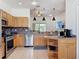 Well-lit kitchen features wooden cabinets, stainless steel appliances, and a tile floor for a delightful cooking space at 16113 Rambling Rd, Odessa, FL 33556