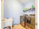 This laundry room features a utility sink, shelving, and front loading washer and dryer at 16113 Rambling Rd, Odessa, FL 33556