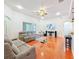 Comfortable living room offers wood floors, a ceiling fan, and an entertainment center for relaxation and enjoyment at 16113 Rambling Rd, Odessa, FL 33556