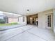 Wide, screened-in patio provides ample space for outdoor dining and relaxation with backyard views at 16113 Rambling Rd, Odessa, FL 33556