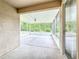Spacious screened-in patio providing an airy outdoor living space with view of the treelined backyard at 16113 Rambling Rd, Odessa, FL 33556